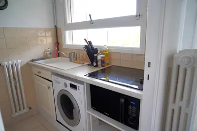 a kitchen with a washing machine and a window at Cannes Studio near Croisette Plage in Cannes