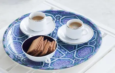 a blue and white plate with cookies and two cups of coffee at Magnifique vue mer, grande terrasse et piscine in Cannes