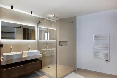 a bathroom with a glass shower and a sink at Luxury suite Forville - Cannes center in Cannes