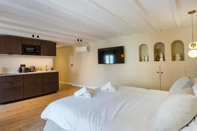a walk in closet with wooden shelves and a window at Luxury suite Forville - Cannes center in Cannes
