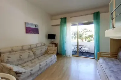 a living room with a couch and a sliding glass door at Rocamare in Cannes