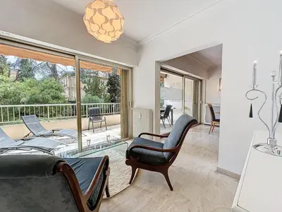 a living room with a couch and a chair at 130m2 Terrasses, Jardin, 4chambres, Climatisation in Cannes