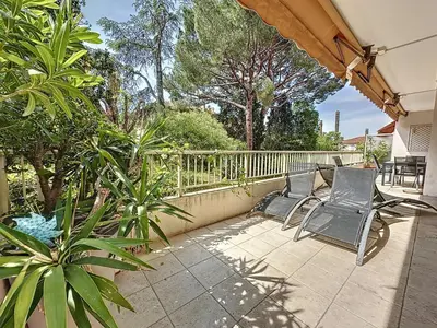 a patio with two chairs and a fence at 130m2 Terrasses, Jardin, 4chambres, Climatisation in Cannes