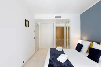 a bedroom with a bed with towels on it at Cristal Croisette YourHostHelper in Cannes