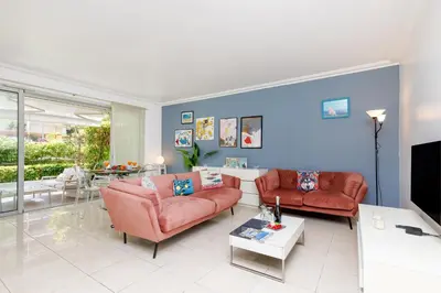 a living room with two couches and a tv at Cristal Croisette YourHostHelper in Cannes