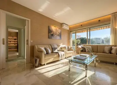 a living room with a couch and a table at B038 Spacieux Appartement proche Croisette parking in Cannes