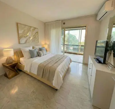 a bedroom with a large bed with a window at B038 Spacieux Appartement proche Croisette parking in Cannes