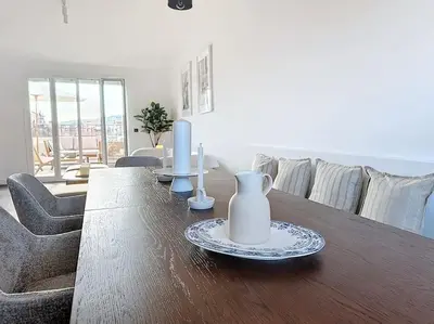 a living room with a wooden table with vases on it at 79m2 Penthouse, Palais et plages à 400m rooftop in Cannes