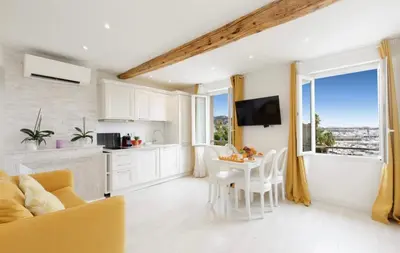 a kitchen and living room with a table and chairs at Palais des Festival view in Cannes