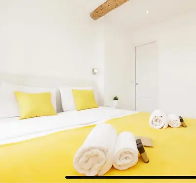 a bedroom with a bed with towels on the floor at Palais des Festival view in Cannes