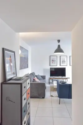 a living room with a couch and a table at Modern apartment with swimming pool in Cannes