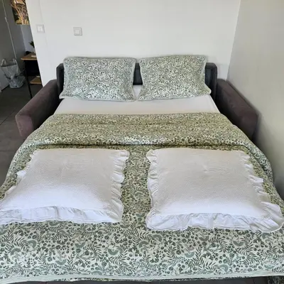 a bed with two pillows on top of it at Studio Cannes le Val D'or Chez Lisa in Cannes