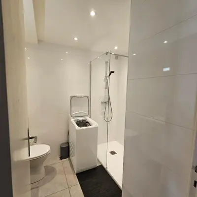 a white bathroom with a toilet and a shower at Studio Cannes le Val D'or Chez Lisa in Cannes