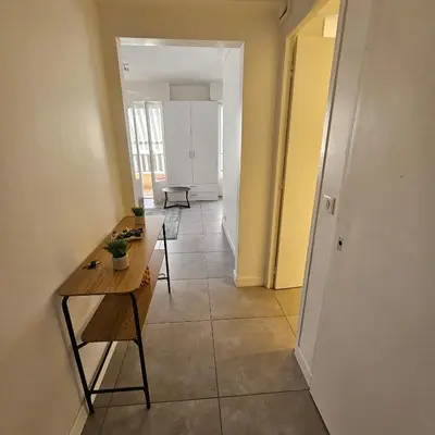 a hallway with a table and chairs in a room at Studio Cannes le Val D'or Chez Lisa in Cannes