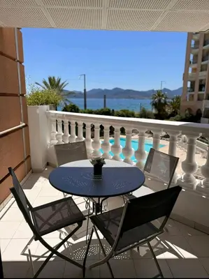 a table and chairs on a balcony with a view at Cannes appartement vue mer , piscine in Cannes