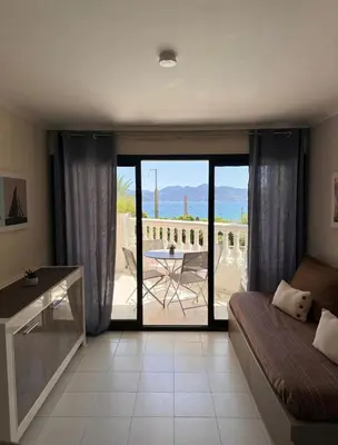 a bedroom with a bed and a view of a patio at Cannes appartement vue mer , piscine in Cannes