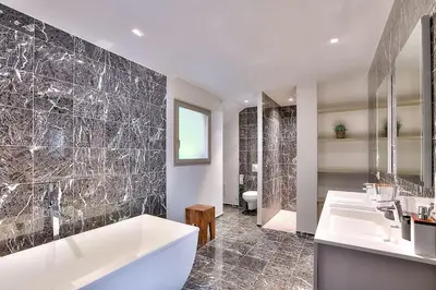 a bathroom with a tub and two sinks and a shower at Villa CANNES in Cannes