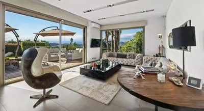 a living room with a table and a chair at Villa CANNES in Cannes
