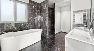 a bathroom with a white tub and a sink at Villa CANNES in Cannes