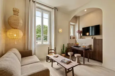 a living room with a couch and a table at Le Bonheur - 5mins Palais des Festivals in Cannes