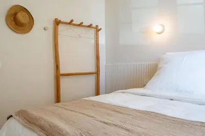 a bedroom with a bed with a wooden head board at Le Bonheur - 5mins Palais des Festivals in Cannes