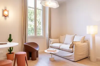 a living room with a couch and a table at Le Bonheur - 5mins Palais des Festivals in Cannes