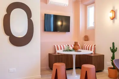 a room with a table and some orange stools at Le Bonheur - 5mins Palais des Festivals in Cannes