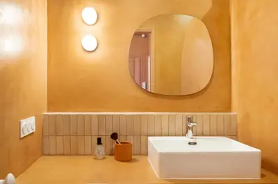 a bathroom with a white sink and a mirror at Le Bonheur - 5mins Palais des Festivals in Cannes