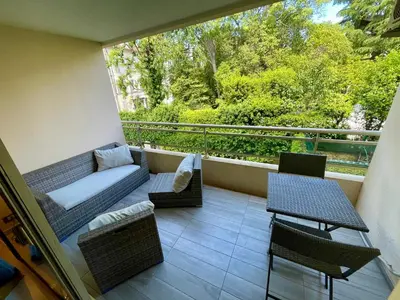 a balcony with a couch and tables and chairs at Isola Bella by Connexion in Cannes