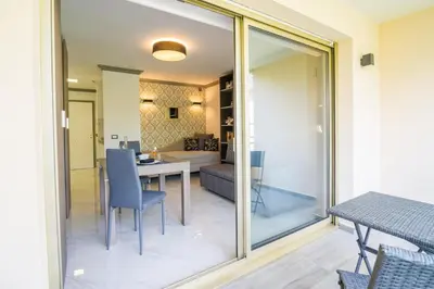 a dining room and living room with sliding glass doors at Isola Bella by Connexion in Cannes