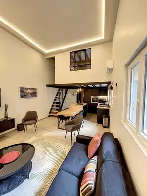 a living room with a couch and a table at BRP Cannes Center,Two-Bed Deluxe Apart with Spa bath in Cannes