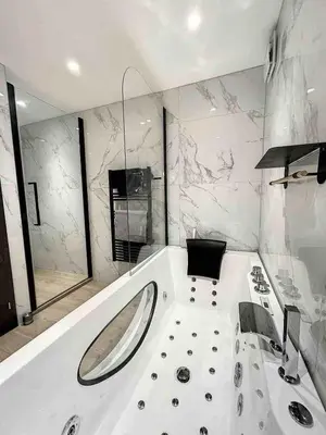 a bathroom with a tub with a sink at BRP Cannes Center,Two-Bed Deluxe Apart with Spa bath in Cannes