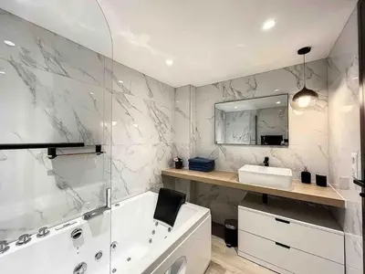a bathroom with a tub and a sink and a mirror at BRP Cannes Center,Two-Bed Deluxe Apart with Spa bath in Cannes