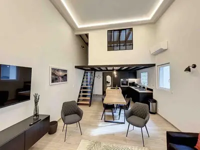 a large living room with a table and chairs at BRP Cannes Center,Two-Bed Deluxe Apart with Spa bath in Cannes