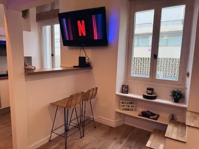 a room with two stools and a television on the wall at Cannes Croisette Festival Plage Mer in Cannes
