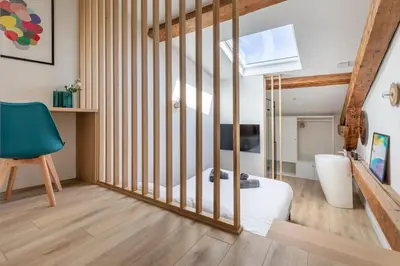 a bedroom with a bed and a stair case at BRP Cannes Center, Top floor Luxurious Apartment II, 4 bedrooms+3 bathrooms in Cannes