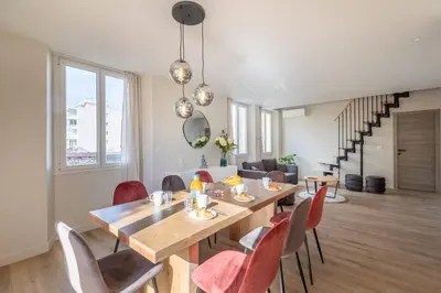 a dining room with a wooden table and chairs at BRP Cannes Center, Top floor Luxurious Apartment II, 4 bedrooms+3 bathrooms in Cannes