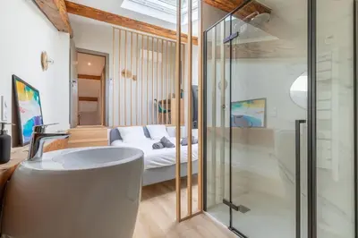 a bathroom with a bath tub next to a bed at BRP Cannes Center, Top floor Luxurious Apartment II, 4 bedrooms+3 bathrooms in Cannes