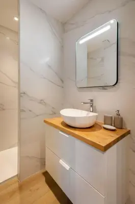 a white bathroom with a sink and a mirror at BRP Cannes Center, Top floor Luxurious Apartment II, 4 bedrooms+3 bathrooms in Cannes
