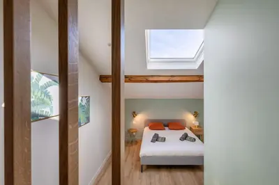 a bedroom with a bed and a window at BRP Cannes Center,Top floor Luxurious house,8 bed in Cannes