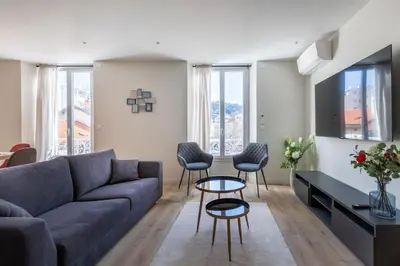 a living room with a couch and chairs and windows at BRP Cannes Center,Top floor Luxurious house,8 bed in Cannes