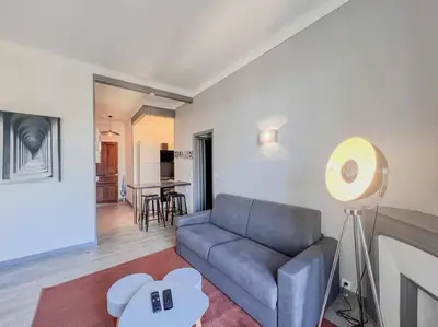 a living room with a couch and a table at Cannes - Charming central apartment with balcony in Cannes