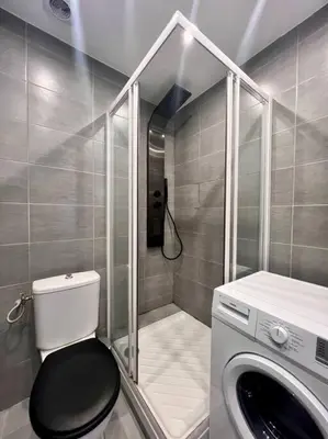 a bathroom with a toilet and a washing machine at Cannes - Charming central apartment with balcony in Cannes