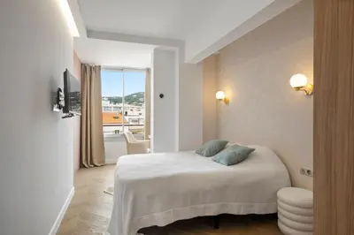 a bedroom with a bed and a view of a balcony at Luxury Romantic Cannes 45 Croisette Two Bedrooms in Cannes