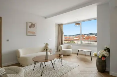 a living room with a couch and a table at Luxury Romantic Cannes 45 Croisette Two Bedrooms in Cannes