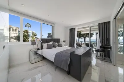 a bedroom with a large bed and large windows at REF 1337 - Cannes Croisette - Sea view apartment for rent in Cannes