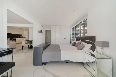 a bedroom with a large bed and a living room at REF 1337 - Cannes Croisette - Sea view apartment for rent in Cannes
