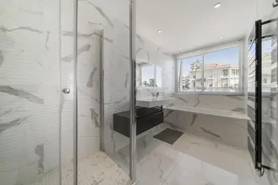 a bathroom with a walk in shower and a sink at REF 1337 - Cannes Croisette - Sea view apartment for rent in Cannes