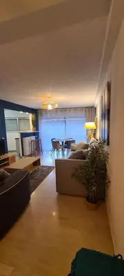 a living room with a couch and a table at Le Ptit Ecrin du Lerins in Cannes