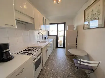 a kitchen with a sink and a stove top oven at Cannes proche Croisette - Appartement 3 Pièces vue mer terrasse Helv7 in Cannes
